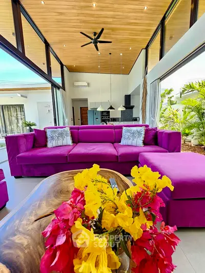 Luxurious modern living room with vibrant purple sofa and high ceilings, perfect for stylish entertaining.