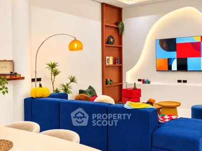 Modern living room with vibrant decor and wall-mounted TV