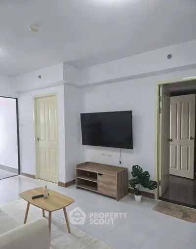 Modern living room with wall-mounted TV and minimalist decor