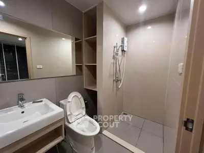 Modern bathroom with sleek fixtures and spacious shower area