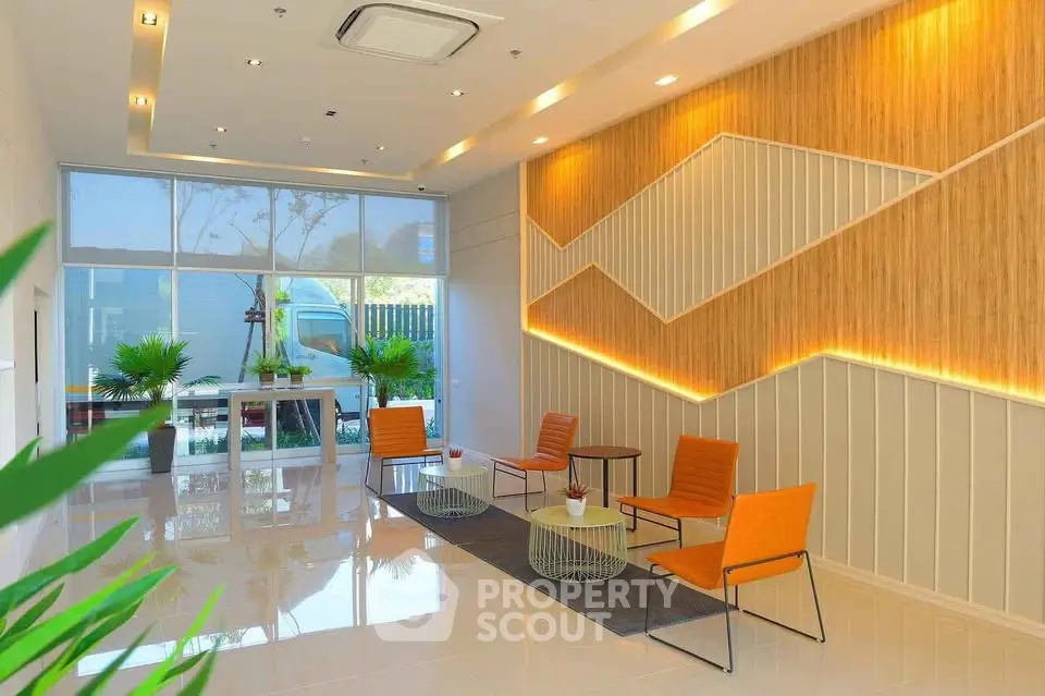 Modern lobby with stylish seating and decorative wall accents in a contemporary building.