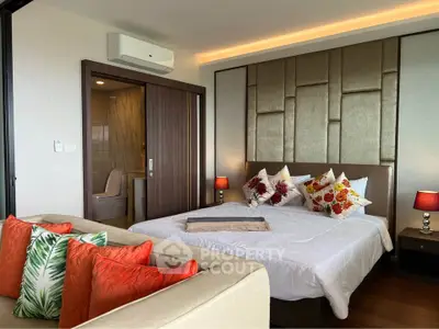 Luxurious bedroom with modern decor and ensuite bathroom in a stylish apartment.