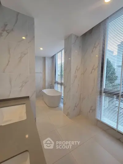 Luxurious bathroom with elegant marble tiles and freestanding bathtub