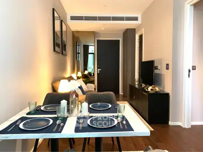 Modern dining area with elegant table setting in a stylish apartment interior.