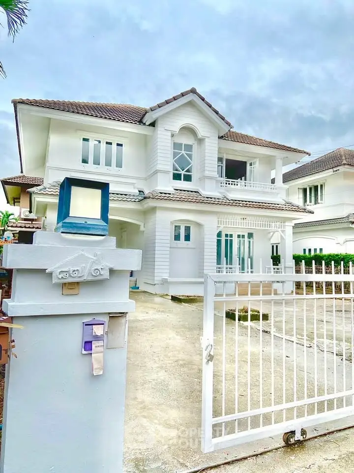 Stunning two-story white house with elegant architecture and spacious driveway.