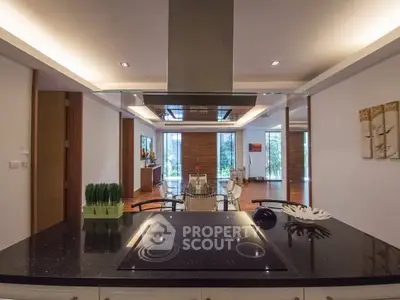 Modern kitchen with sleek black countertop and open layout in luxury home