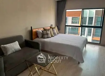 Modern bedroom with large window and stylish decor in urban apartment