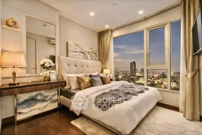 Luxurious bedroom with stunning city view, elegant decor, and plush bedding in a high-rise apartment.