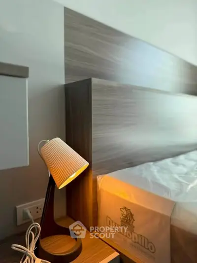 Modern bedroom with stylish lamp and Dunlopillo mattress, showcasing contemporary design and comfort.