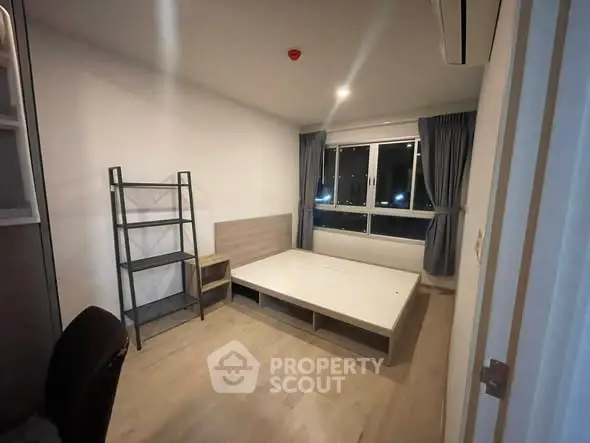 Modern bedroom with large window and minimalist furniture