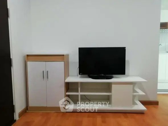 Modern living room with sleek TV stand and cabinet on wooden floor