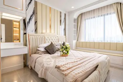 Luxurious bedroom with elegant decor and large window offering natural light.