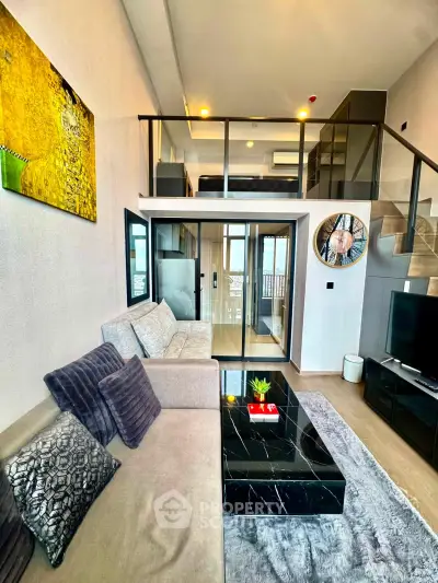 Modern loft-style living room with mezzanine, stylish decor, and large windows for natural light.