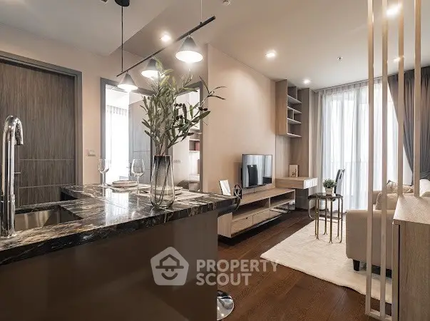 Modern open-plan living room with stylish kitchen and cozy seating area.