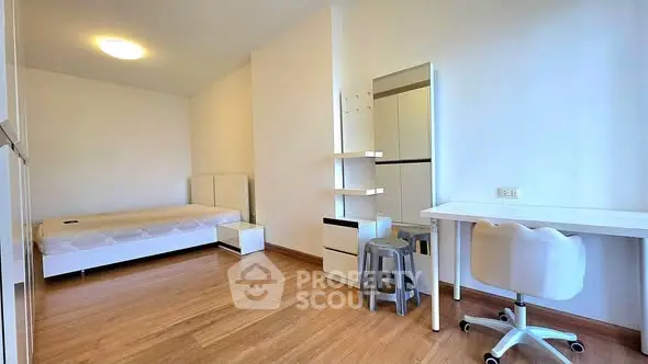 Spacious modern bedroom with minimalist design and wooden flooring