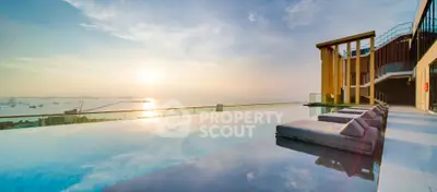Luxurious rooftop infinity pool with stunning ocean view at sunset
