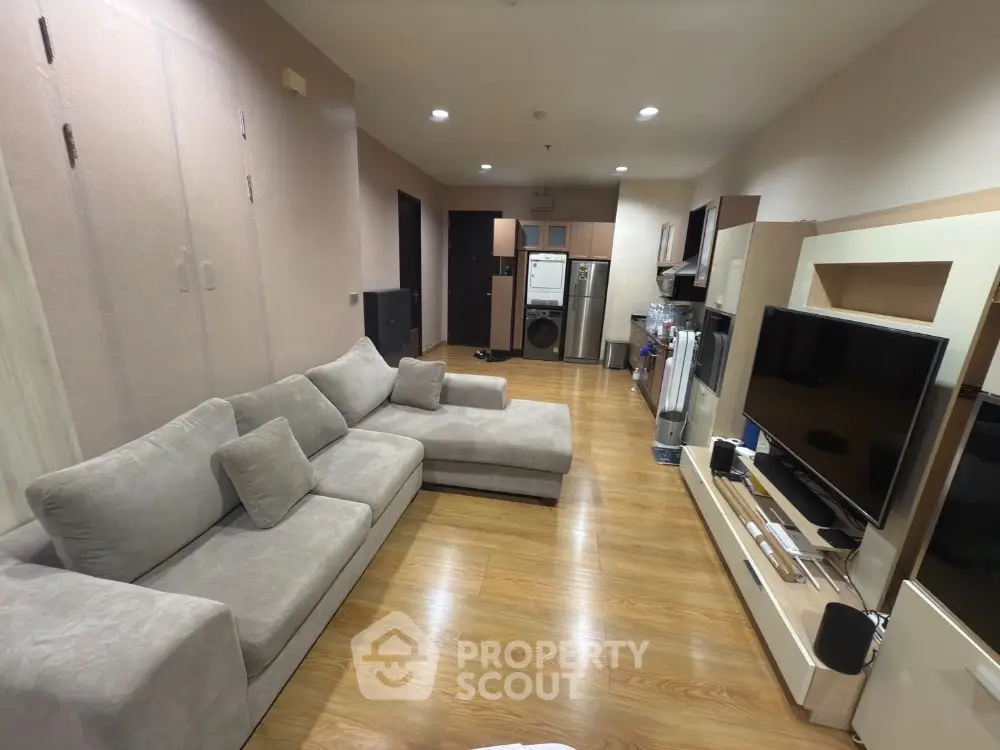 Spacious living room with modern furniture and entertainment center
