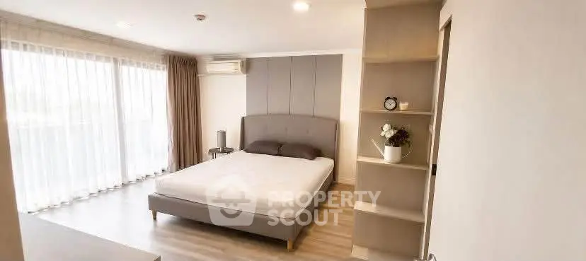 Spacious modern bedroom with large windows and elegant decor