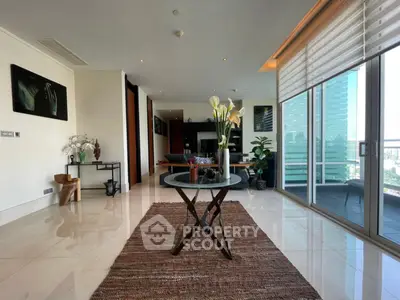 Luxurious living room with modern decor and stunning city view from large windows.