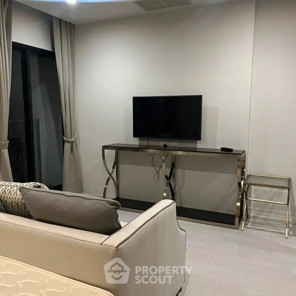 Modern living room with sleek TV stand and cozy sofa, perfect for relaxation and entertainment.