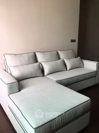 Elegant living room with modern gray sectional sofa and cozy ambiance.