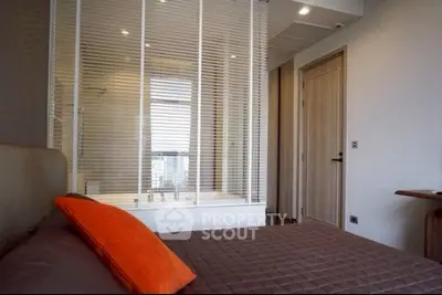 Modern bedroom with stylish decor and large window view