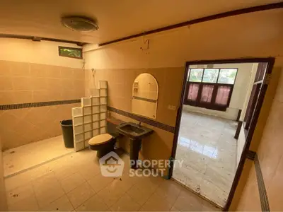 Spacious bathroom with unique design and adjacent room view