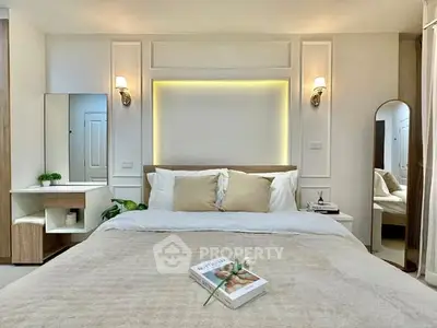 Luxurious bedroom with elegant decor and cozy ambiance, featuring a stylish bed and modern lighting.