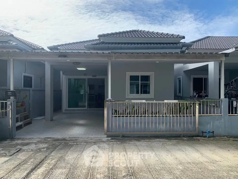 Charming single-story home with tiled roof and spacious front patio in a serene neighborhood.