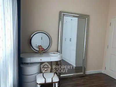 Elegant bedroom corner with vanity and large mirror, perfect for stylish living.