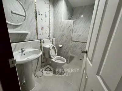 Modern bathroom with elegant tile design and sleek fixtures in a contemporary home.