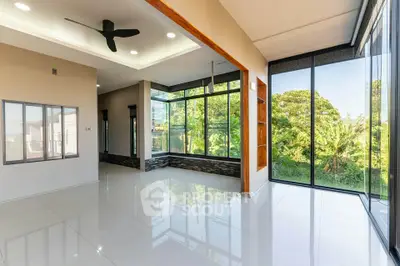 Spacious modern living room with large windows and garden view