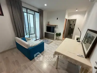 Modern living room with balcony access and stylish decor in a cozy apartment.
