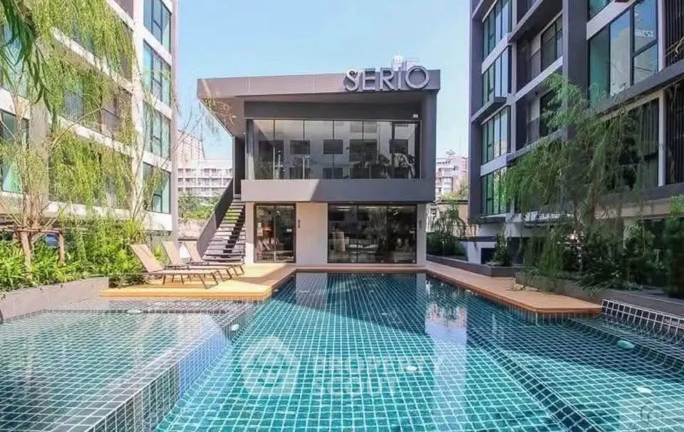 Modern condominium with luxurious pool and stylish architecture in urban setting.