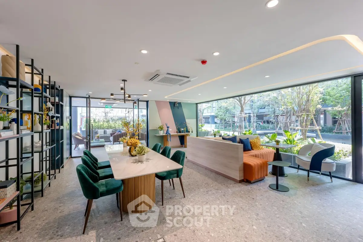 Modern living room with stylish decor and large windows overlooking a lush garden, perfect for relaxation.