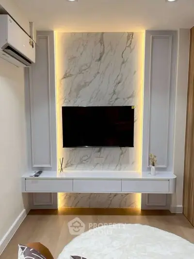 Modern living room with stylish TV wall and ambient lighting