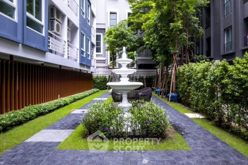 Charming garden courtyard with elegant fountain in modern residential complex