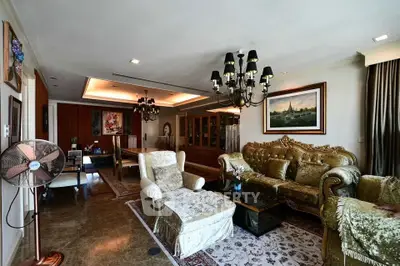 Luxurious living room with elegant chandelier and plush velvet furniture in a spacious open layout.