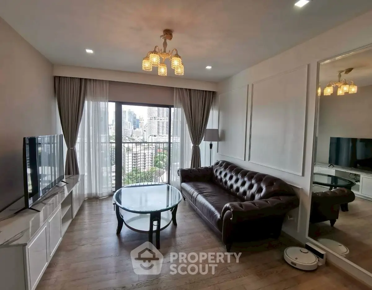 Elegant living room with city view, leather sofa, and modern decor