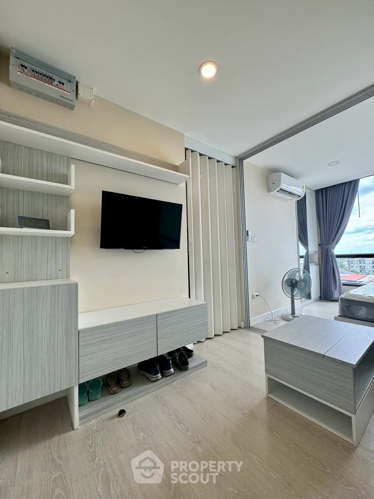Modern living room with sleek furniture and balcony view