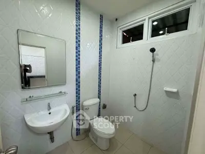 Modern bathroom with sleek white tiles and contemporary fixtures