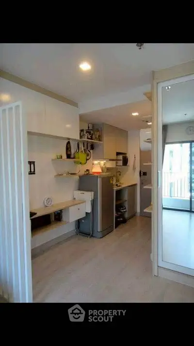 Modern compact kitchen with sleek cabinetry and open layout in a stylish apartment.