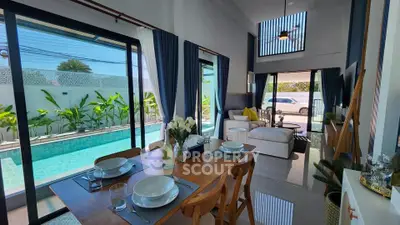 Luxurious living room with pool view, modern decor, and elegant dining setup