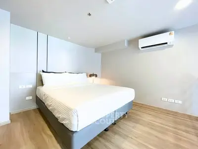 Modern bedroom with sleek design and air conditioning in a bright apartment.