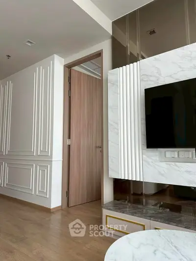 Modern living room with elegant wall paneling and sleek TV setup