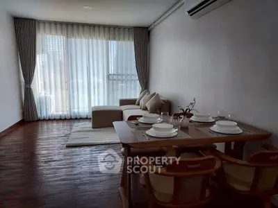 Spacious living room with elegant dining area and natural light