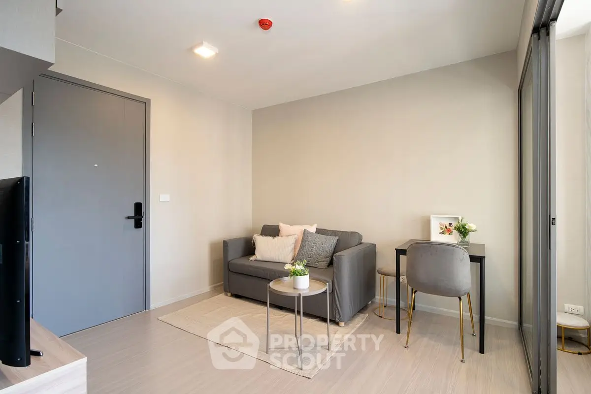 Modern living room with cozy sofa and stylish decor in a bright apartment.