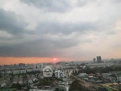 Stunning cityscape view at sunset with expansive skyline and residential areas.