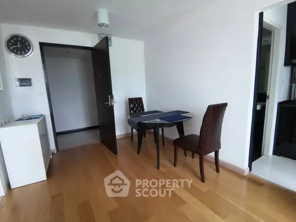 Cozy dining area with wooden flooring and elegant chairs in modern apartment
