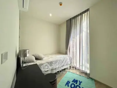 Cozy bedroom with natural light and modern decor, perfect for relaxation and comfort.